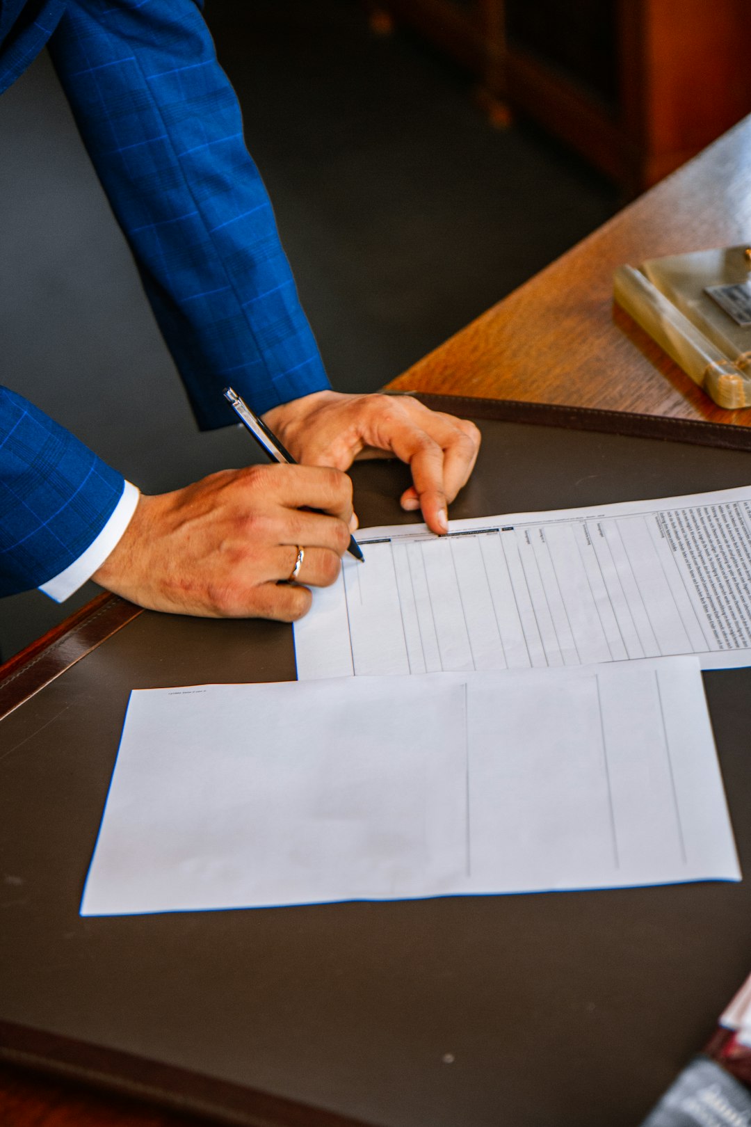 person-writing-on-white-form-paper-9i5eqbarv-k